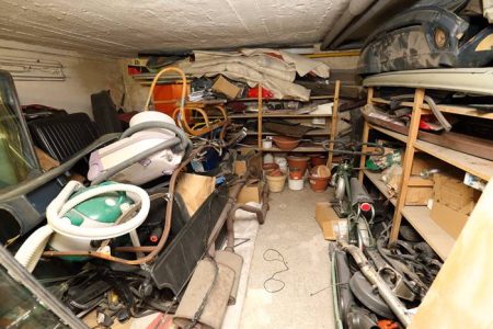 Low cellar full of trash, old vacuum cleaners Low cellar full of trash, old vacuum cleaners and vehicle parts